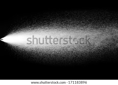 close up of a spray bottle drops on black background