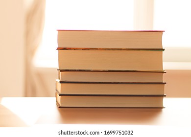 close up of a stack of books on the table