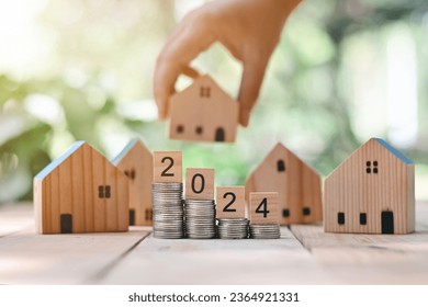 close up stack of coin, 2024 wooden block text and toy wood house on table, saving and manage money for building, home insurance business technology, subprime mortgage crisis risk and problem concept - Shutterstock ID 2364921331