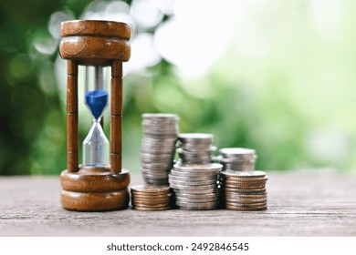 close up stack of coin and hourglass on wood table, saving and manage money to success business, economic crisis risk and problem concept - Powered by Shutterstock