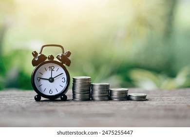 close up stack of coin and small alarm clock on table, saving and manage time to success business, economic crisis risk and problem concept
