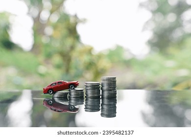 close up stack of coin and toy car on table, saving and manage money for transport, transportation insurance business technology, economic crisis risk and problem concept - Shutterstock ID 2395482137
