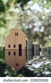 Close Up Stack Of Coin And Toy Wood House On Table, Saving And Manage Money For Building, Home Insurance Business Technology, Subprime Mortgage Crisis Risk And Problem Concept