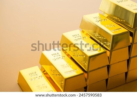 Close up stack gold bars as rise up stairs on yellow background. Gold price increase, investment in commodity market trading, etf, risk mnagement concept. Gold is safe haven in economy crisis, war.