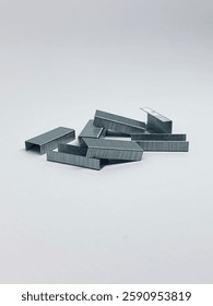 Close up stack of metal staples for staple. Isolated on white background.
