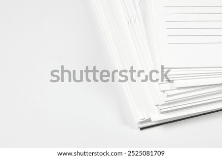 Close up stack of note papers isolated on white background.  Stationery item.