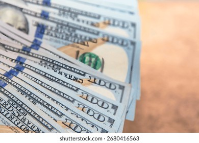Close up of a stack of US one hundred dollar banknotes. Concept of finance money wealth savings investment and banking background