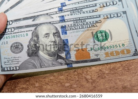 Close up of a stack of US one hundred dollar banknotes. Concept of finance money wealth savings investment and banking background