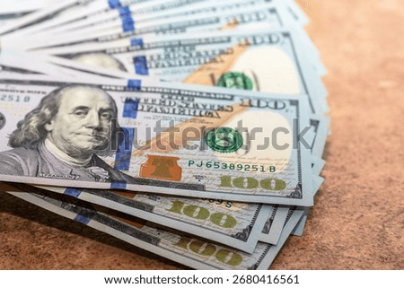 Close up of a stack of US one hundred dollar banknotes. Concept of finance money wealth savings investment and banking background
