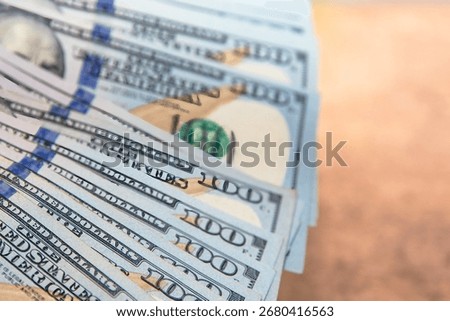 Close up of a stack of US one hundred dollar banknotes. Concept of finance money wealth savings investment and banking background