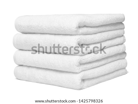 close up of a stack of white towels bathroom on white background