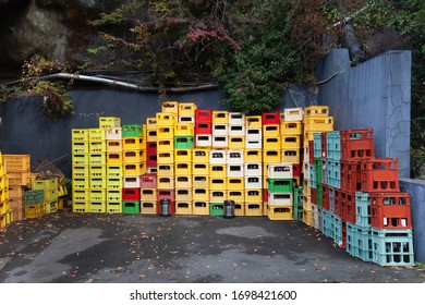 A Close Up Of Stacks Of Plastic Multicolor Crates Containing Beer And Soft Drink Bottles In Japan. Old Beverage Plastic Bottle, 