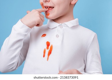 Close up stain tomato sauce spilling on white clothes. the child fingers tastes the tomato sauce. daily life stain concept.  - Shutterstock ID 2138373091
