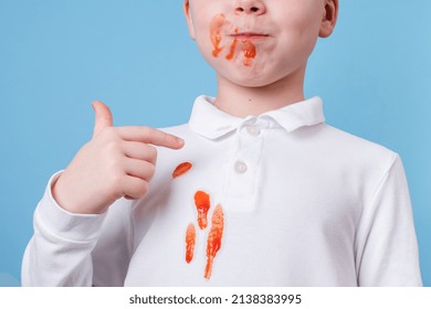 Close Up Stain Tomato Sauce Spilling On White Clothes. The Child Fingers Tastes The Tomato Sauce. Daily Life Stain Concept. 