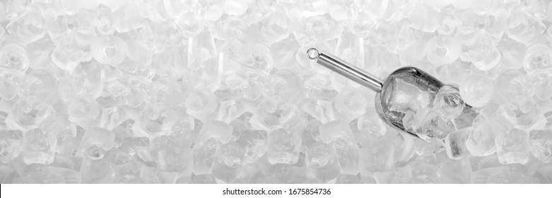 Close up stainless ice scoop with ice cubes in bucket top view use for food and beverage background