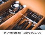 Close up of stainless steel forks in a drawer. Stainless steel cutler. Drawer equipped for kitchen furniture