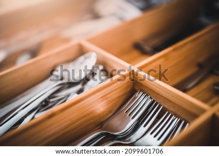 Close up of stainless steel forks in a drawer. Stainless steel cutler. Drawer equipped for kitchen furniture