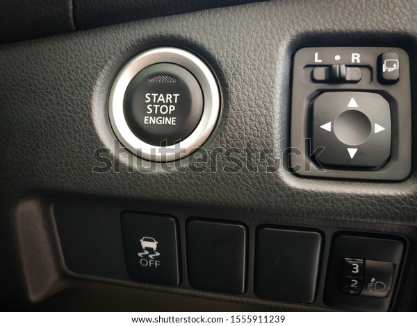 close up the Start\
Stop Engine button and the rear view mirror button, black interior\
dashbord on modern cars