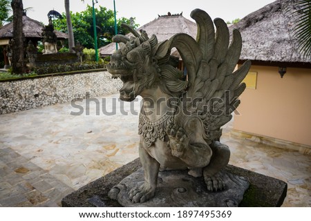 Close up of statue of Singha Barong Winged Lion Spirit (Griffin) for daily worship or prayer. Mythical creature in Hinduism of Balinese culture. No people.