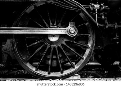 Close up of a steam train wheel in black and white