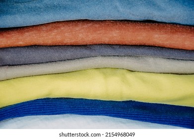 close up stecks of multicolored light clothes background