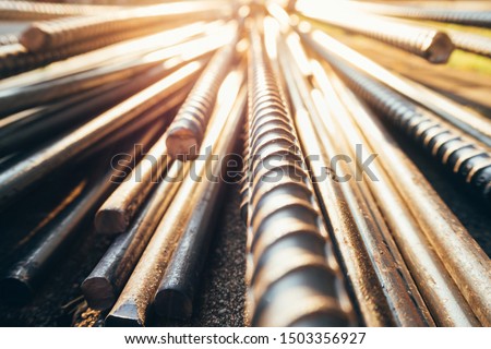 close up steel bar or steel reinforcement bar in the construction site with sunbeam at the morning, steel rods bars can use for reinforce concrete. 