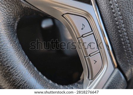 Close Up of Steering Wheel Audio Control Buttons in Modern Car