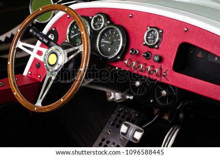 Close up steering wheel of classic car and in side car in the motor show hall