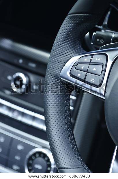 Close up of steering wheel commands in modern\
luxurious car