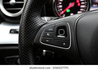 Close up steering wheel with function buttons. New car SUV steering wheel. Buttons on the steering wheel, hands-free system. Сruise control on the steering wheel.