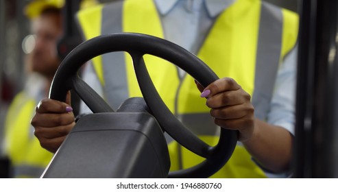 Close Up Of Steering Wheel Of Modern Forklift In Industrial Warehouse. Cropped Shot Of Storehouse Driver Using Forklift Truck. Logistics And Goods Shipping Concept