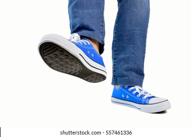 Close Up Of Steps Of A Person With Sneakers And Jeans Walking Isolated White Background