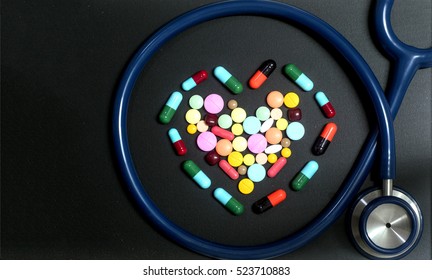 Close up of stethoscope with different pharmaceutical stuff 
Heart shape