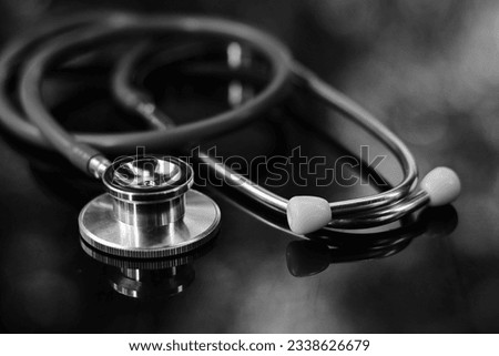 close up stethoscope on table, world health day, medical and healthcare, life insurance business technology, global pandemic crisis risk and problem concept, black and white tone