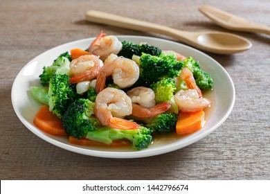 close up of stir fried broccoli with shrimps in a ceramic dish on wooden table. homemade style food concept. - Powered by Shutterstock