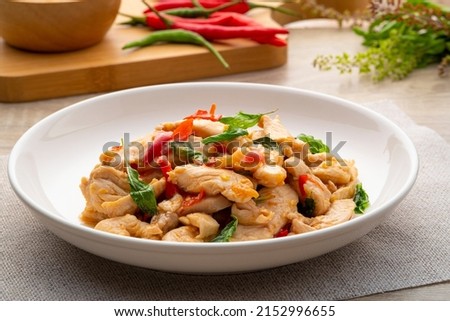 Close up Stir-Fried sliced chicken breast with Basil on white plate