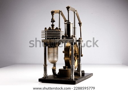 close up of a stirling engine construction with white table and white background