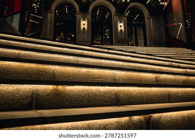 Close up of stone steps with integrated light strips at night.
