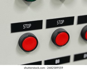 Close up of stop button on control panel of industrial power plant.