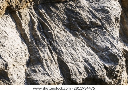 Close up of stratified rock layer texture with shadow