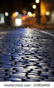 Close Up Of Street With Cobble Stones At Night