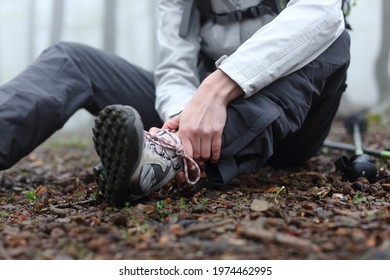 Close up of a stressed trekker complaining alone in the mountain with broken ankle