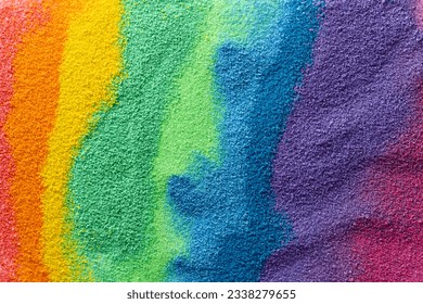Close up of stripes of rainbow coloured sand and copy space background. Sand, texture, movement, shape and colour concept.