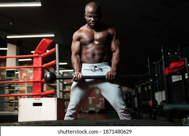 Close Up Of Strong Muscular Man Holding Big Sledge Hammer. Portrait Of Shirtless Bodybuilder Building Muscles In Gym In Dark Atmosphere. Concept Of Crossfit, Sport.