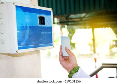 Close Up Student Hand Using A Student Card For Time Attendance Record.