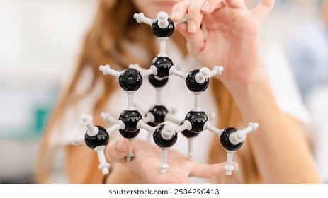 Close up of student hold science molecular model, chemistry molecular structure in school laboratory. Student with molecular model in science chemistry class. Chemistry model in science class - Powered by Shutterstock