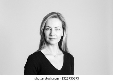 Close Up Studio Portrait Of A Beautiful Woman In The Black Dress Against White Background