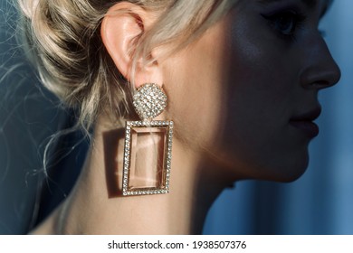 Close Up Studio Portrait Of A Pretty Blonde Woman. Designer Jewelry, Shine On The Neck.