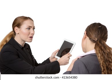 Close Up Studio Shot Of Two Pretty Business Women.  One Is Looking Very Concerned About The Tablet Computer In Her Hand.  The Other Woman Is Seen From Behind.  Isolated On White