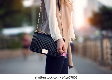 Close up of stylish female black leather bag outdoors. Fashionable and luxury style expensive female bag. - Powered by Shutterstock